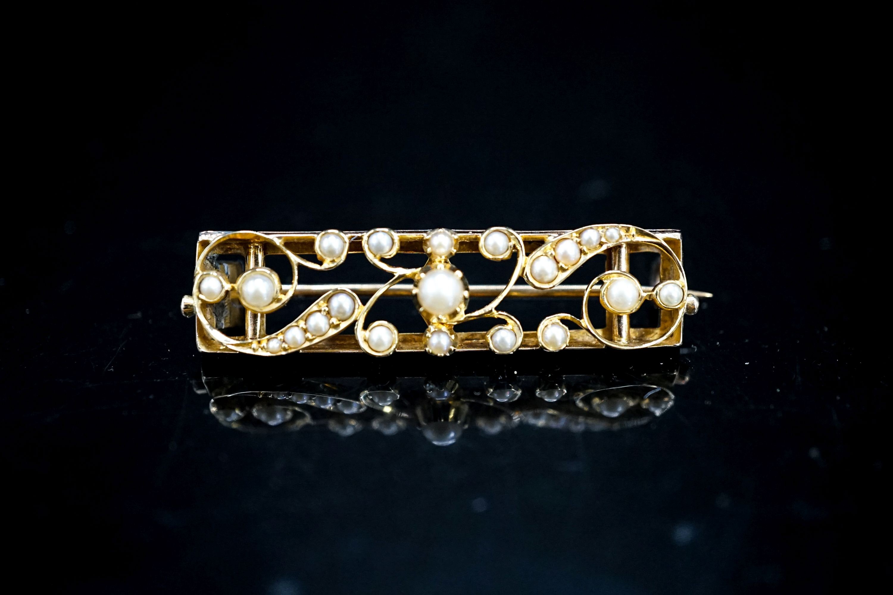 An early 20th century yellow metal and seed pearl set rectangular bar brooch, 38mm